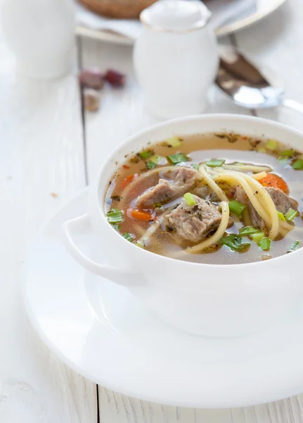 Meat soup with vermicelli in a white tureen — Stock Photo, Image