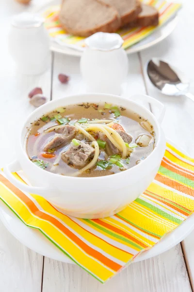 Nourishing soup with vermicelli and beef in a white tureen — Stock Photo, Image