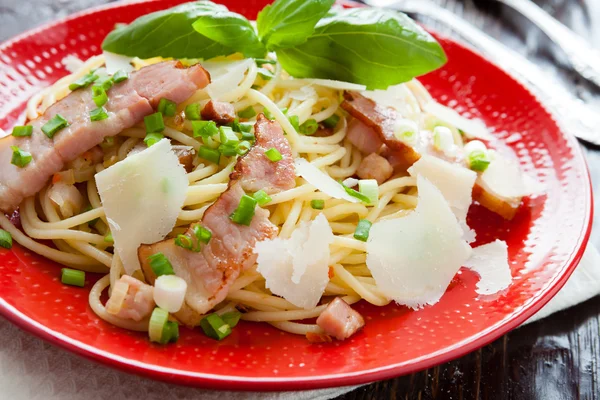 Pasta with fried bacon and parmesan flakes — Stock Photo, Image