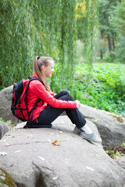 Girl sitting on a large stone, autumn nature — Stock Photo, Image