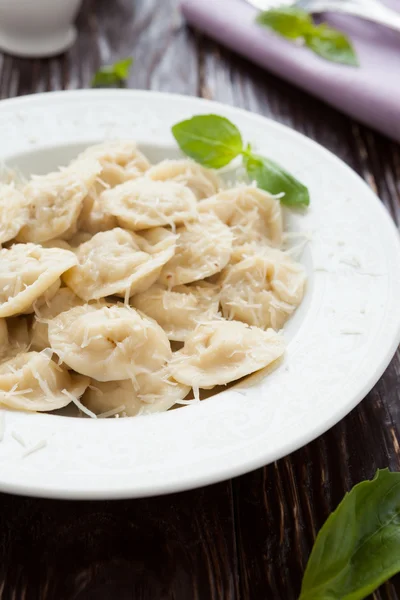 Homemade ravioli with parmesan cheese in a white bowl — Stock Photo, Image