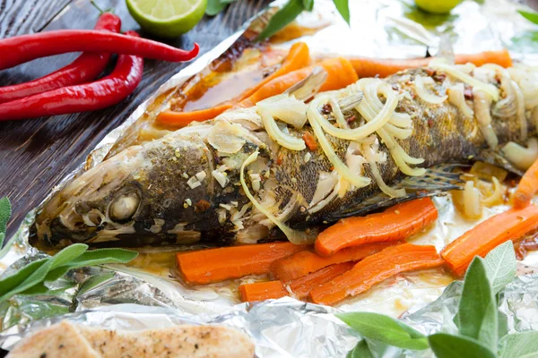 Baked fish with carrots and onions in foil — Stock Image Baked fish with carrots and onions in foil Royalty Free Stock Images