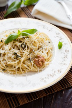 spaghetti with grated Parmesan cheese and walnut sauce clipart