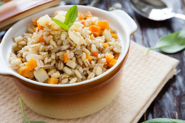 Barley porridge with root vegetables in a pot — Stock Photo, Image