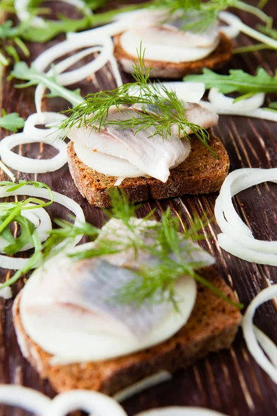 Herring on a piece of rye bread canapés — Stok Foto