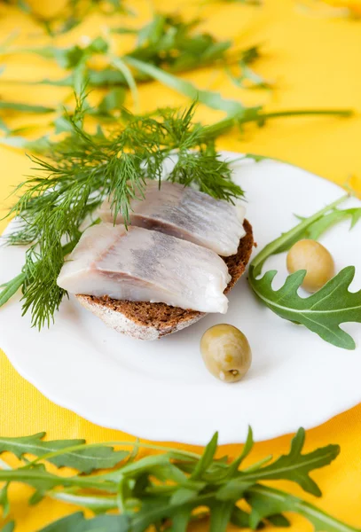 Salted herring on a piece of bread, canape — Stock Photo, Image