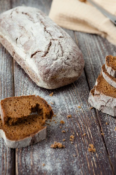 Whole-grain bread with cracks on the boards — Stock Photo, Image