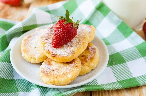 Cheese pancakes with powdered sugar and strawberries — Stock Photo, Image