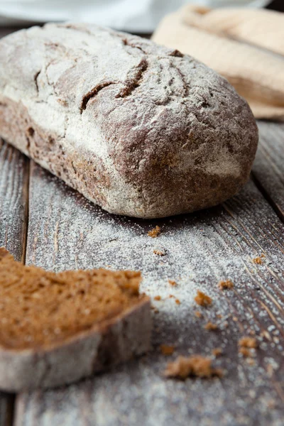Fragrant fresh bread on a board with flour — Stock Photo, Image