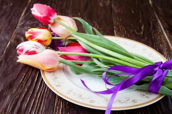 Náručí tulipány na talíři — Stock fotografie