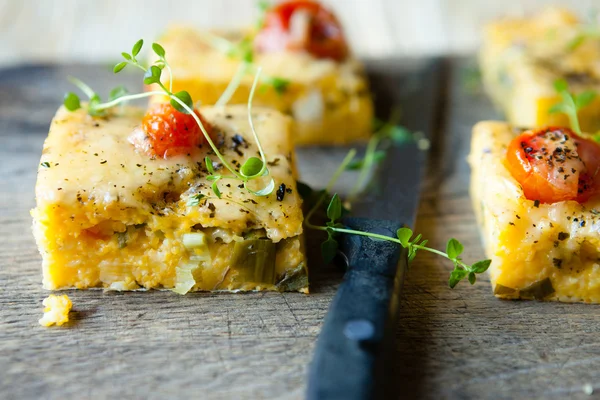 Polenta with tomato pieces on the board — Stock Photo, Image