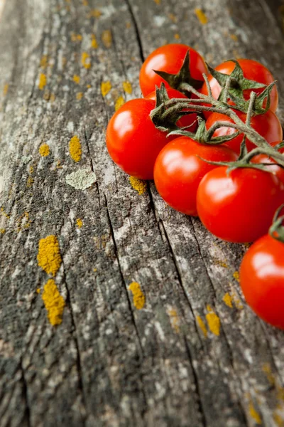 Cherry tomatoes on the board — Stock Photo, Image