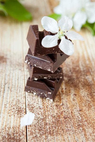 Stack of dark chocolate pieces with nuts