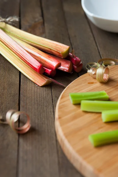 Bunch of rhubarb and pieces on the board — Stock Photo, Image