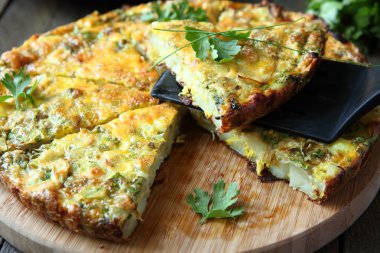 Italian Frittata with slices of fresh greens clipart