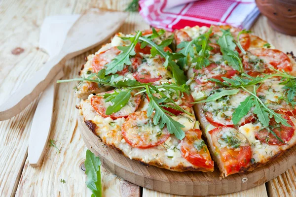 Zelfgemaakte pizza met tomaten, kaas en rucola — Stockfoto