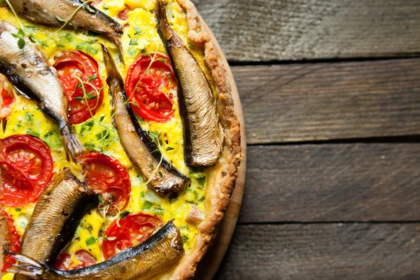 Quiche with a fish on the wooden table — Stock Photo, Image