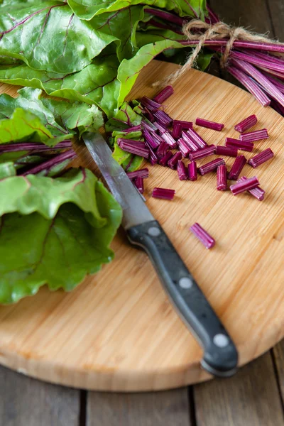 Fresh leaves of chard and a knife — Stock Photo, Image