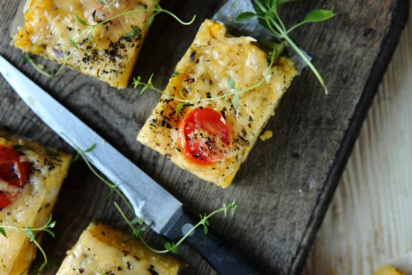 Polenta with tomato, cheese and herbs — Stock Photo, Image