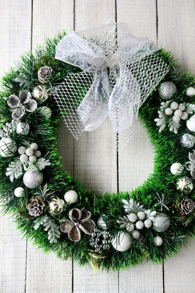 green Christmas wreath on the white door