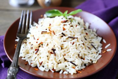 plate full of cooked rice, white and wild