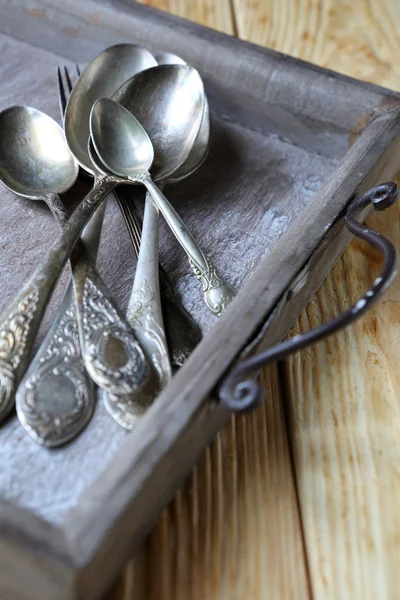 Cupro-nickel spoons on an old tray — Stock Photo, Image