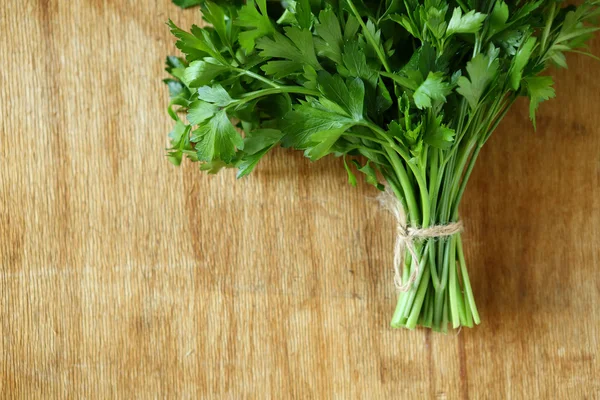 bundle of fresh herbs on a wooden surface