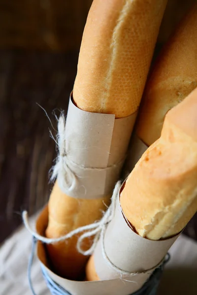 Freshly baked baguettes tied with paper — Stock Photo, Image