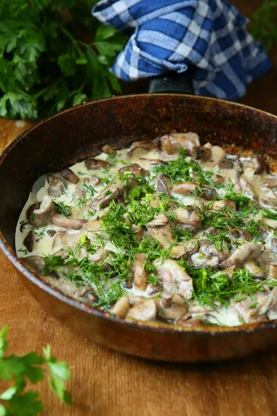Mushrooms with cream sauce in a pan — Stock Photo, Image