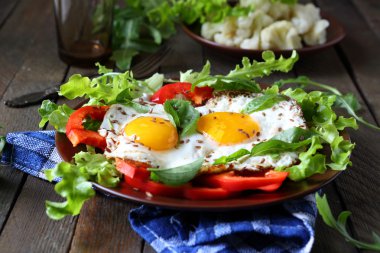 fried eggs with herbs and paprika for breakfast