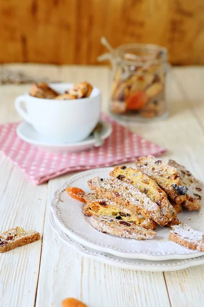 Homemade biscotti on a white plate and a cup — Stock Photo, Image