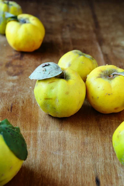 Fresh quince on an old table — Stock Photo, Image