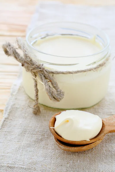 Hausgemachte saure Sahne im Glas und auf dem Löffel — Stockfoto