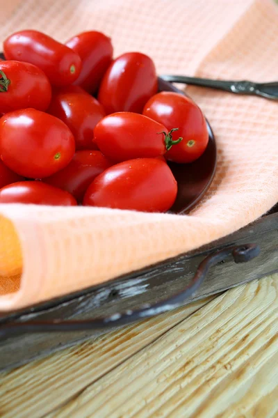 ripe tomatoes on plate on tray