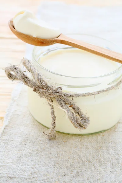 Sour cream in a small glass jar — Stock Photo, Image