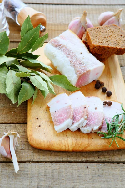 Salty bacon with bread and spices — Stock Photo, Image