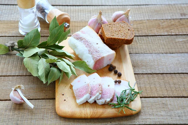 Salty bacon with black bread and garlic — Stock Photo, Image