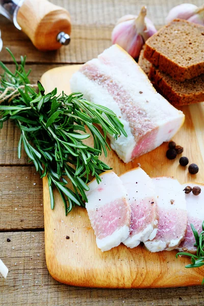 Bacon with black bread and rosemary — Stock Image Bacon with black bread and rosemary Royalty Free Stock Images