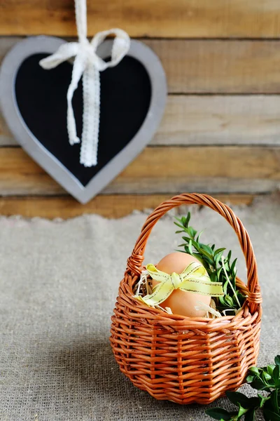 Egg in a wicker basket mini — Stock Photo, Image