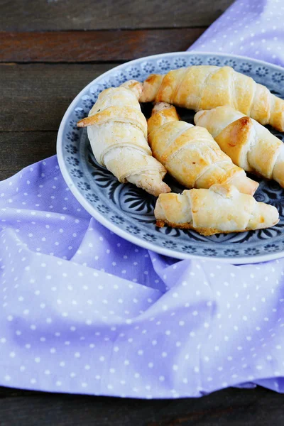 Golden croissants on a plate — Stock Photo, Image