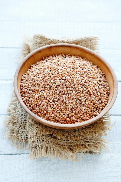 Raw buckwheat in a ceramic bowl — Stock Photo, Image