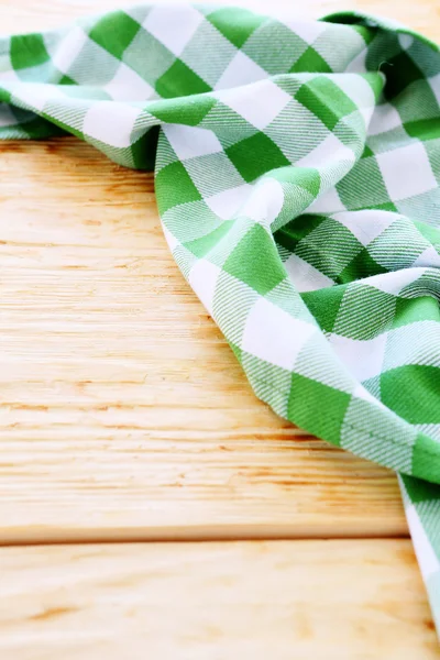 Wooden table covered with green tablecloth — Stock Photo, Image