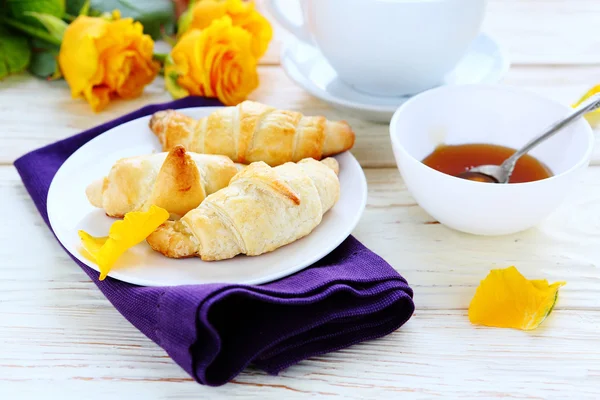Croissants with honey for breakfast — Stock Photo, Image
