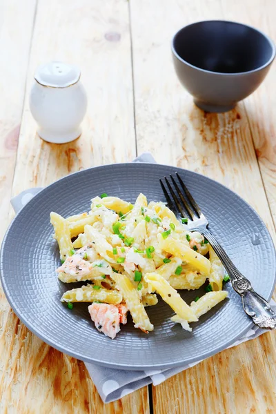 Penne pasta with slices of salmon — Stock Photo, Image