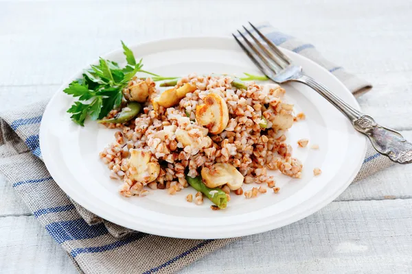 Buckwheat porridge with mushrooms fried — Stock Photo, Image