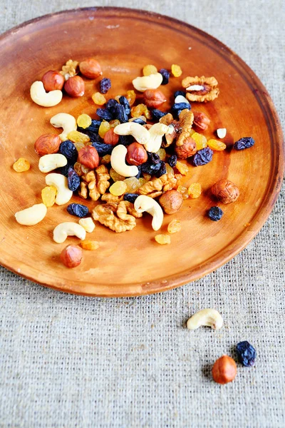 Mix nuts and dried fruits on a plate — Stock Photo, Image