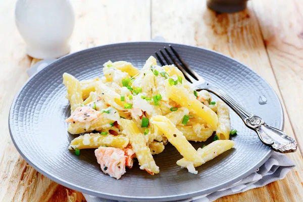 Pasta with cheese sauce and salmon — Stock Photo, Image
