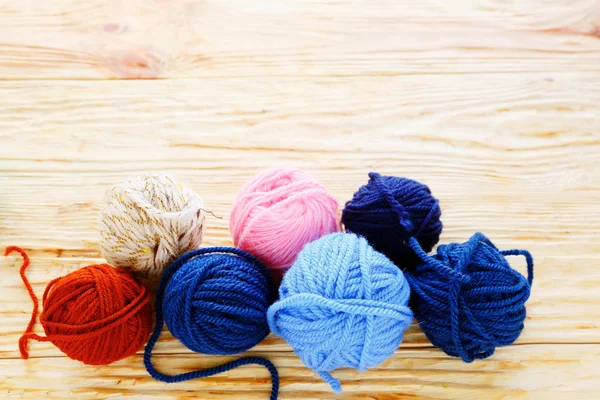 Balls of colored yarn on the boards — Stock Photo, Image