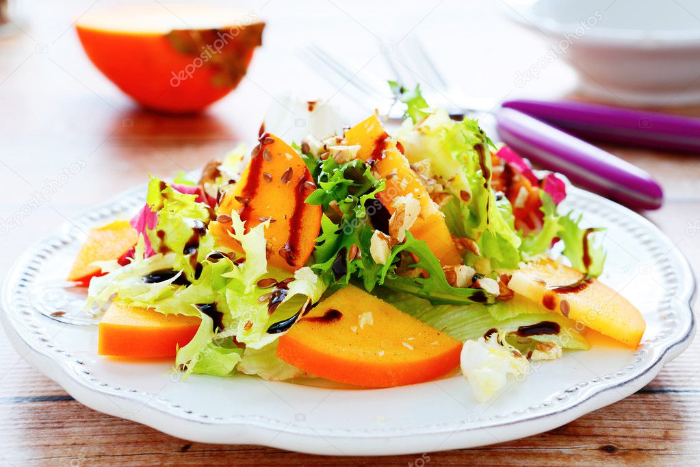 fresh salad with persimmons and nuts