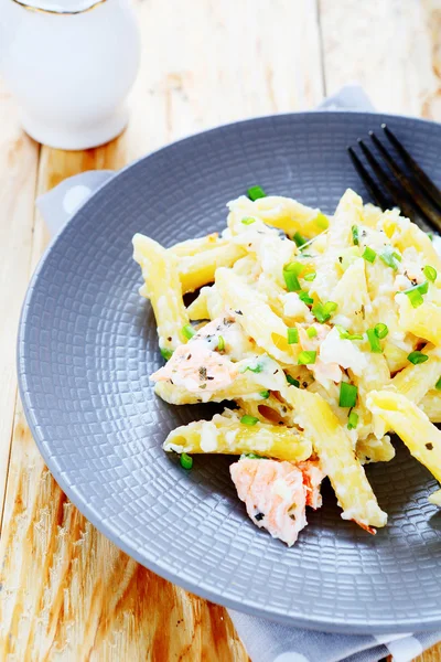 Pasta with pieces of fish and cheese — Stock Photo, Image